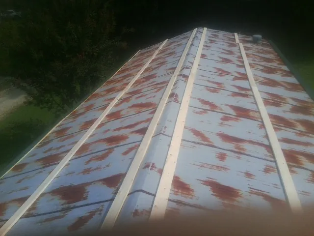 Rusted metal roof panels with new wood purlins before replacement — Storm Damage Roof Repair in Cortez by Roofing Brothers